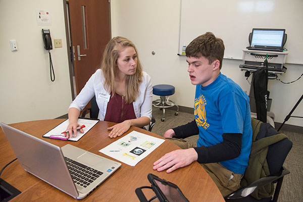 student working with a speech patient