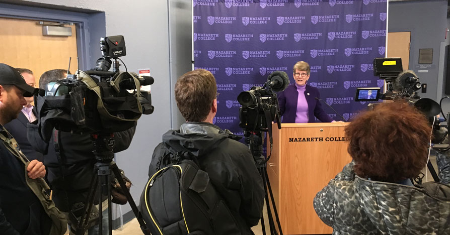 Beth Paul answers questions from journalists at a news conference at Nazareth College.