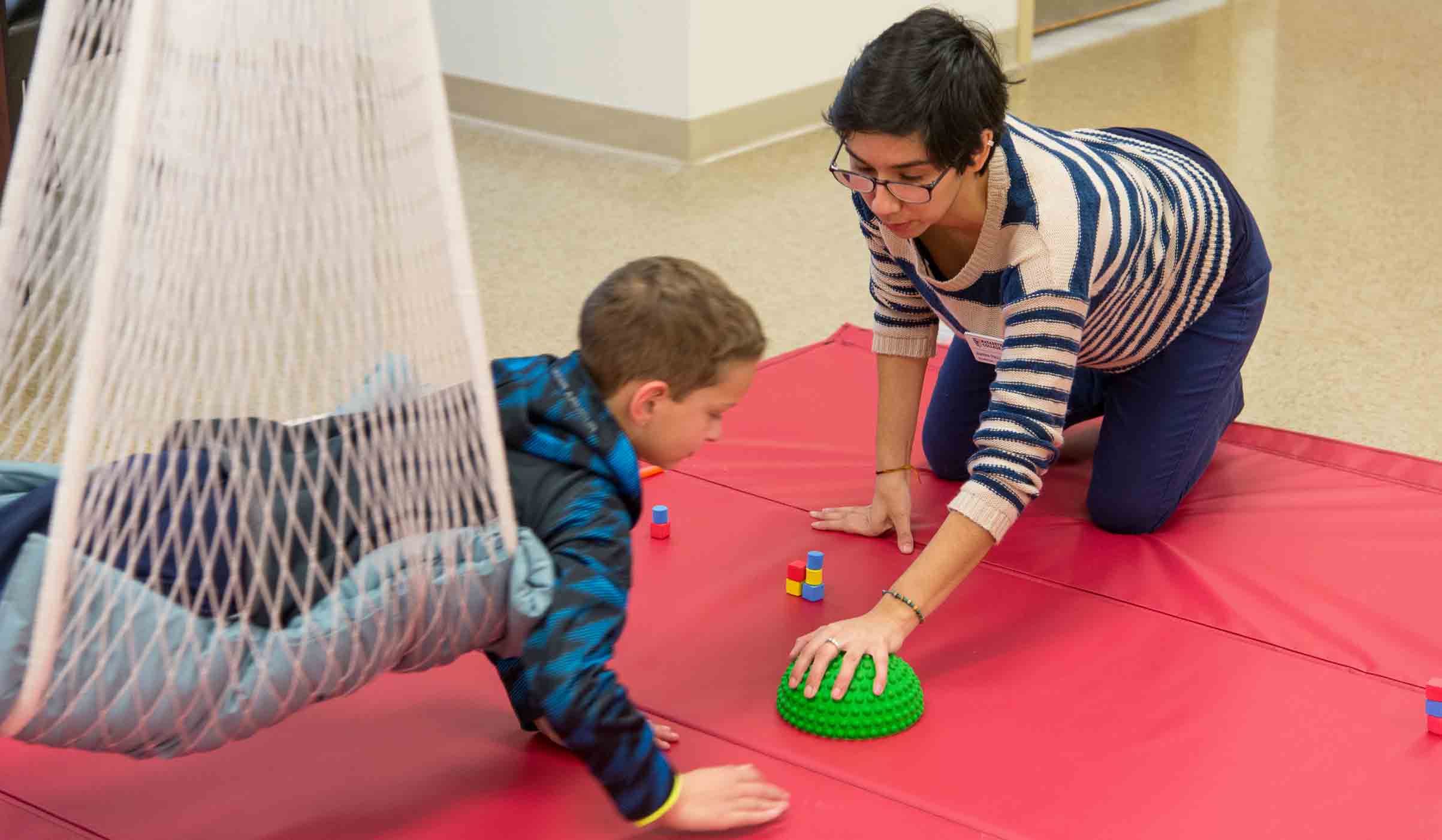 Contact otclinic@naz.edu Child and student work in Occupational Therapy clinic