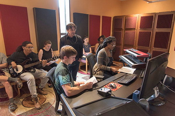 music class in a recording studio with their professor