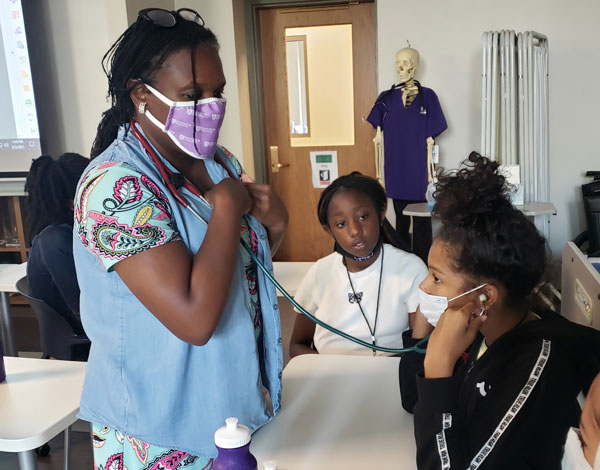 Prof. Marie Bell uses stethoscope with STEM campers